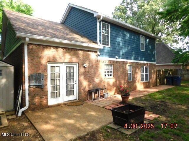 5881 Morganton Dr, Olive Branch, MS 38654 - rear view of house with brick siding, a shingled roof, and a patio area