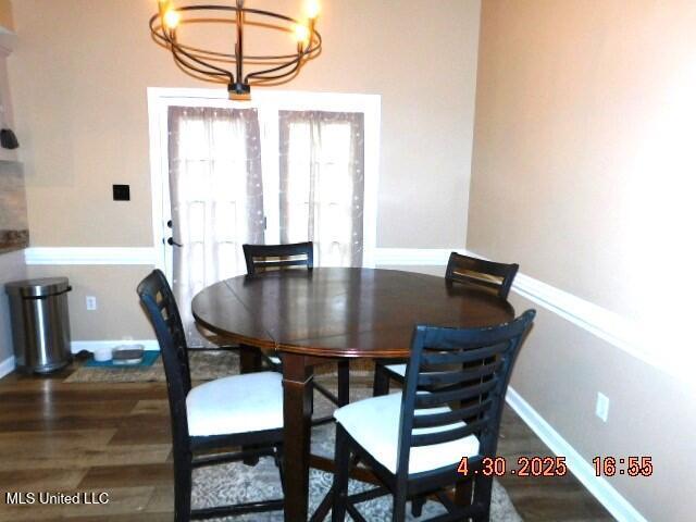 5881 Morganton Dr, Olive Branch, MS 38654 - dining room featuring baseboards, a chandelier, and wood finished floors