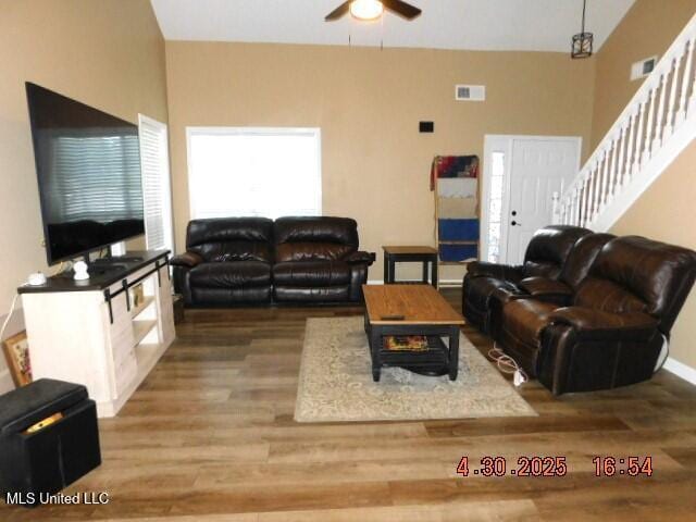 5881 Morganton Dr, Olive Branch, MS 38654 - living area featuring ceiling fan, visible vents, wood finished floors, baseboards, and stairs