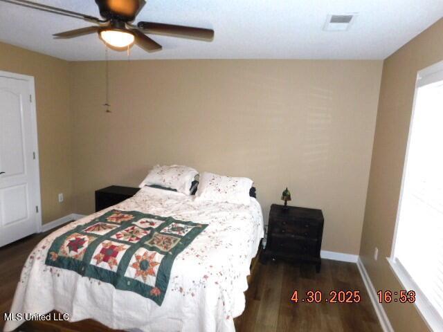 5881 Morganton Dr, Olive Branch, MS 38654 - bedroom with baseboards, dark wood finished floors, ceiling fan, and visible vents
