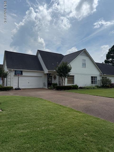 3831 Lake Village Cv, Olive Branch, MS 38654 - view of front of property with driveway, an attached garage, and a front lawn