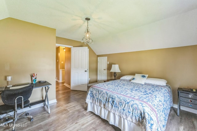 3831 Lake Village Cv, Olive Branch, MS 38654 - bedroom featuring vaulted ceiling, wood finished floors, and an office area