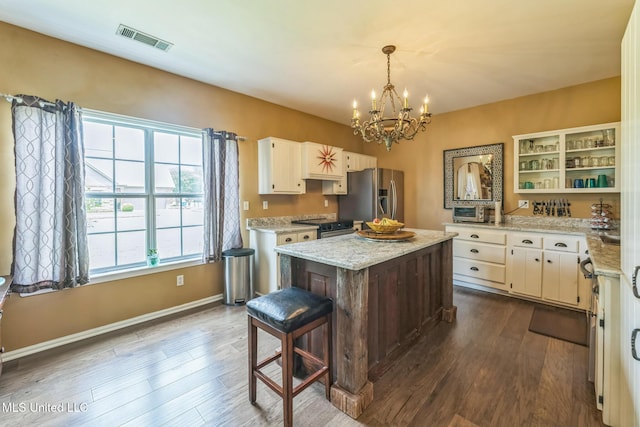 3831 Lake Village Cv, Olive Branch, MS 38654 - kitchen featuring appliances with stainless steel finishes, open shelves, a chandelier, and dark wood-style flooring