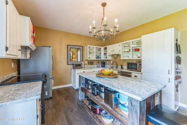 3831 Lake Village Cv, Olive Branch, MS 38654 - kitchen featuring stainless steel appliances, dark wood-style floors, a chandelier, white cabinetry, and open shelves