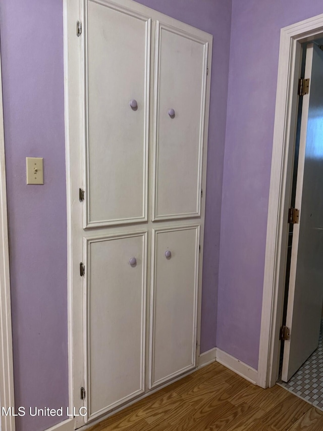 room details with baseboards and wood finished floors