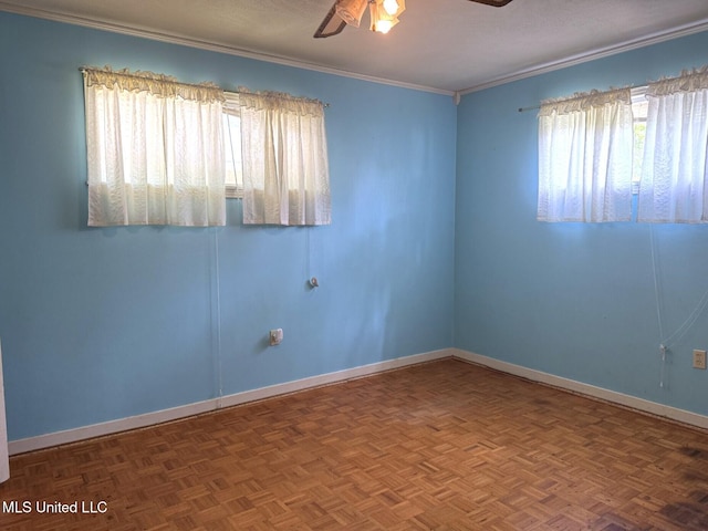 spare room with baseboards, ornamental molding, and ceiling fan