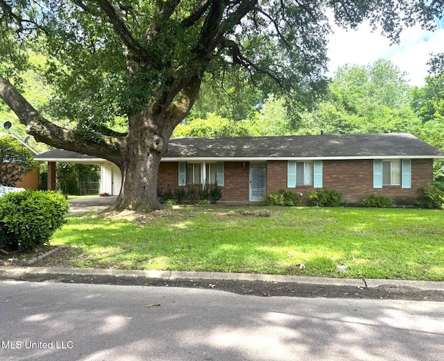 ranch-style home with a carport, a front lawn, and brick siding