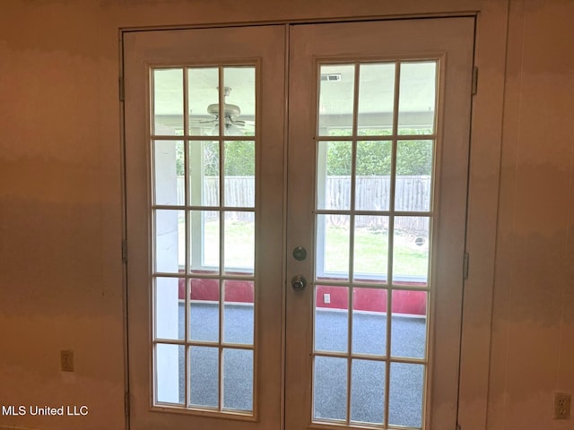 doorway to outside featuring a wealth of natural light, french doors, and a ceiling fan