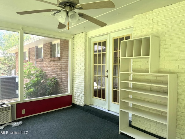 unfurnished sunroom featuring french doors and ceiling fan