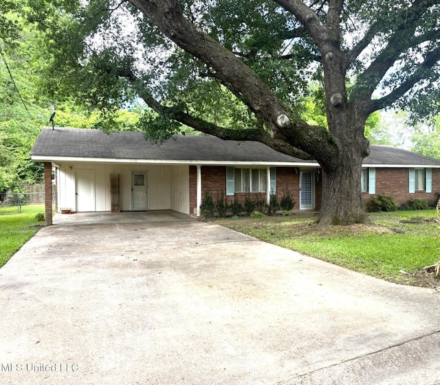 110 Pecan Way, Natchez, MS 39120 - ranch-style house with fence, concrete driveway, brick siding, and a front yard