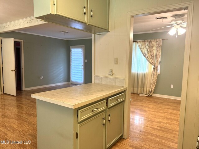 110 Pecan Way, Natchez, MS 39120 - kitchen with ornamental molding, tile countertops, and light wood-style flooring