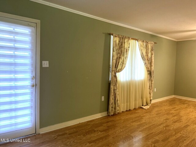 110 Pecan Way, Natchez, MS 39120 - spare room featuring crown molding, a wealth of natural light, wood finished floors, and baseboards