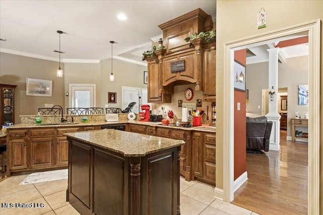 kitchen with kitchen peninsula, sink, light tile patterned flooring, and pendant lighting