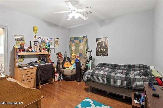 bedroom with ceiling fan and light hardwood / wood-style floors