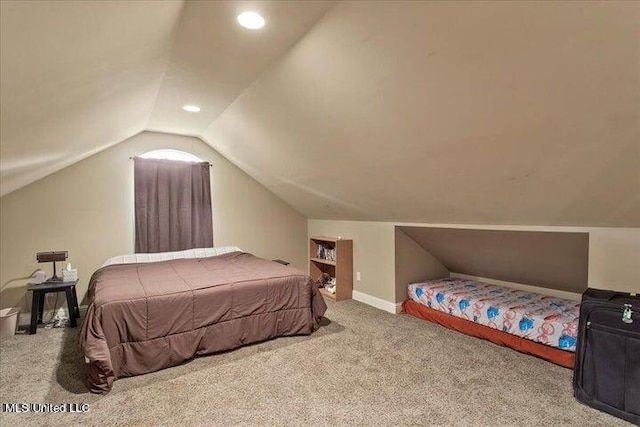 carpeted bedroom featuring lofted ceiling