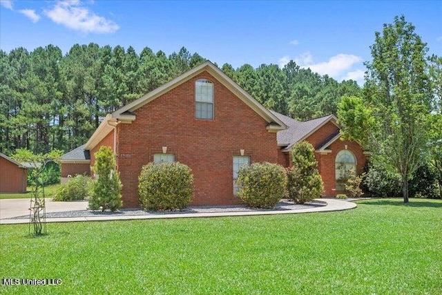 view of side of home featuring a lawn