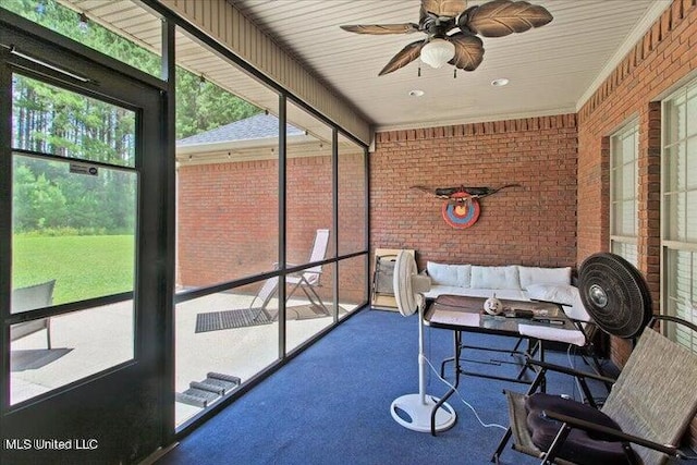 sunroom / solarium featuring ceiling fan