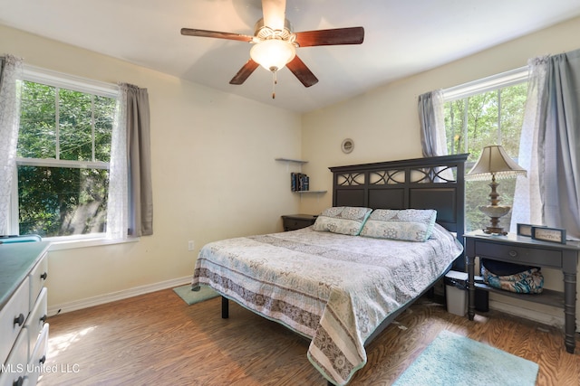 9726 Limu Pl, Diamondhead, MS 39525 - bedroom with wood finished floors, multiple windows, and baseboards