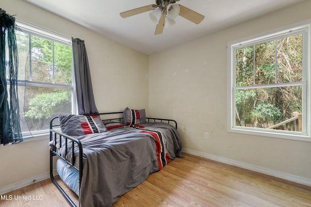 9726 Limu Pl, Diamondhead, MS 39525 - bedroom with wood finished floors, baseboards, and ceiling fan