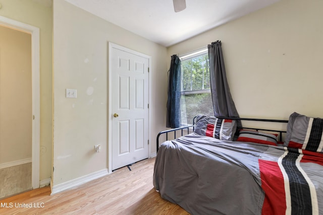9726 Limu Pl, Diamondhead, MS 39525 - bedroom with light wood finished floors, baseboards, and a ceiling fan