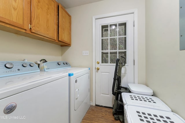 9726 Limu Pl, Diamondhead, MS 39525 - laundry room featuring cabinet space, separate washer and dryer, and wood finished floors