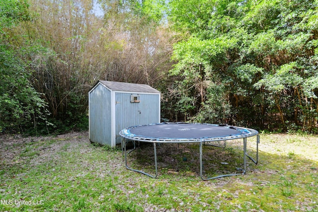 9726 Limu Pl, Diamondhead, MS 39525 - view of yard featuring a trampoline and a forest view
