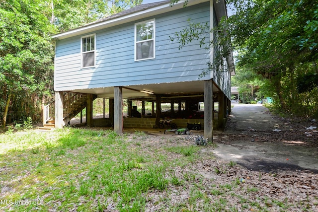 9726 Limu Pl, Diamondhead, MS 39525 - rear view of house featuring stairway and a carport