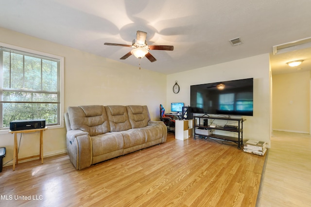 9726 Limu Pl, Diamondhead, MS 39525 - living room featuring light wood-style floors, a ceiling fan, and baseboards