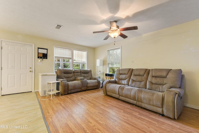 9726 Limu Pl, Diamondhead, MS 39525 - living room featuring ceiling fan, light wood finished floors, and baseboards