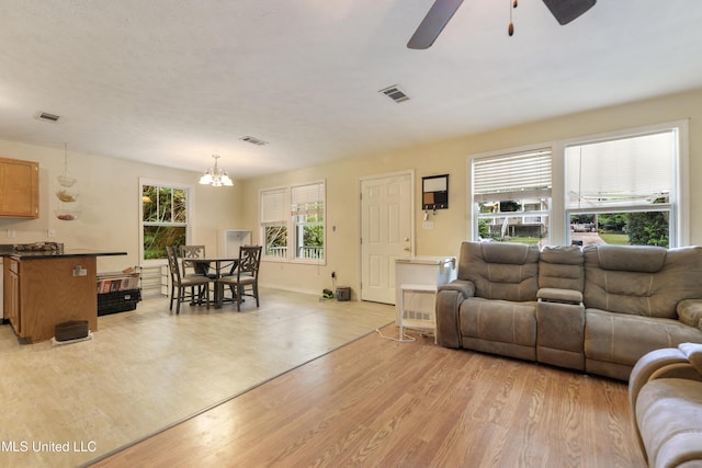9726 Limu Pl, Diamondhead, MS 39525 - living area with ceiling fan, light wood finished floors, a chandelier, and baseboards