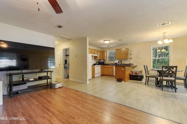 9726 Limu Pl, Diamondhead, MS 39525 - living room with light wood-style flooring, a ceiling fan, a chandelier, and baseboards
