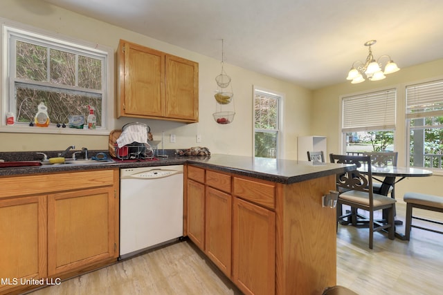 9726 Limu Pl, Diamondhead, MS 39525 - kitchen with dishwasher, a peninsula, light wood-style flooring, and healthy amount of natural light