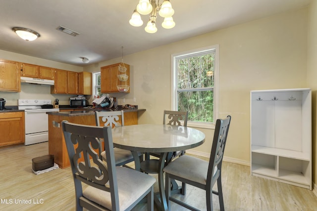 9726 Limu Pl, Diamondhead, MS 39525 - dining space with light wood-style flooring, a chandelier, and baseboards