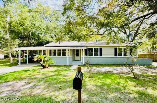 ranch-style house with a front yard and a carport