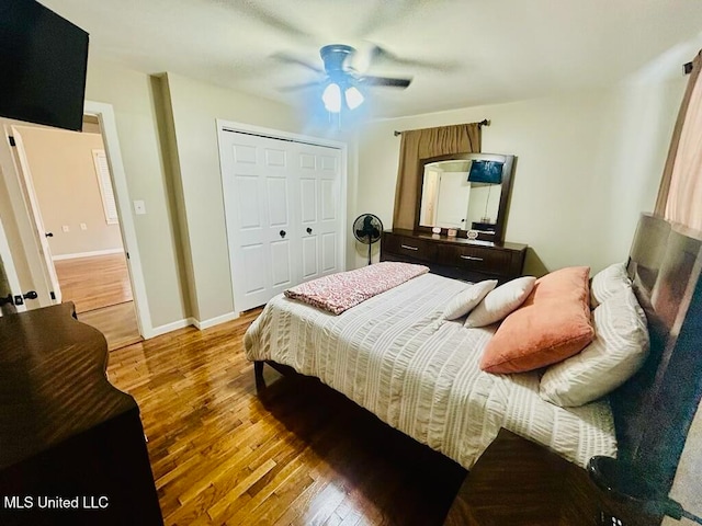 bedroom featuring a closet, hardwood / wood-style floors, and ceiling fan