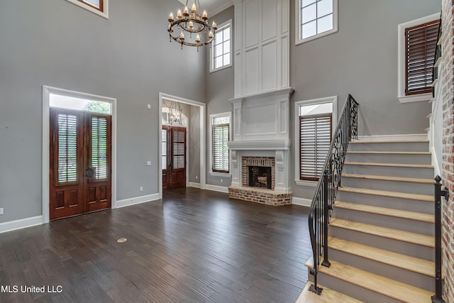 101 Commons Pl, Ridgeland, MS 39157 - foyer entrance featuring a chandelier, a towering ceiling, stairway, and dark wood-type flooring