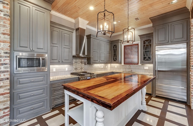 101 Commons Pl, Ridgeland, MS 39157 - kitchen featuring wood counters, crown molding, built in appliances, and a sink