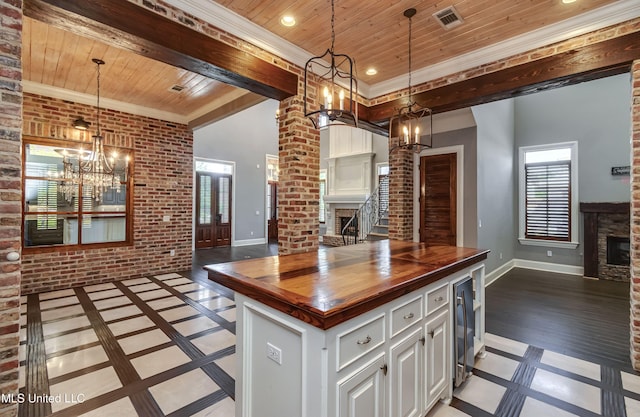 101 Commons Pl, Ridgeland, MS 39157 - kitchen with wood ceiling, a fireplace, a notable chandelier, visible vents, and butcher block countertops