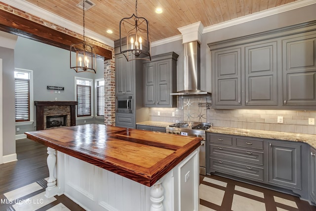 101 Commons Pl, Ridgeland, MS 39157 - kitchen with wooden counters, stainless steel appliances, gray cabinetry, and wall chimney exhaust hood