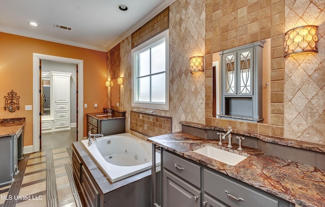 101 Commons Pl, Ridgeland, MS 39157 - full bathroom featuring ornamental molding, a jetted tub, visible vents, and a sink