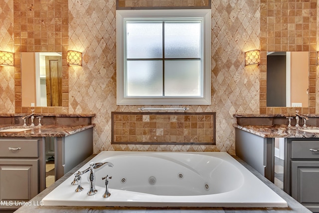 101 Commons Pl, Ridgeland, MS 39157 - full bath with a sink, a jetted tub, two vanities, and tile walls