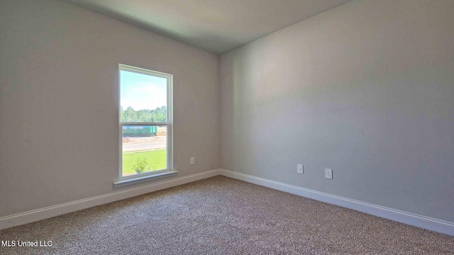 empty room with carpet floors and baseboards