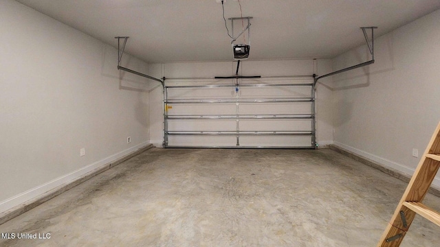 garage featuring a garage door opener and baseboards