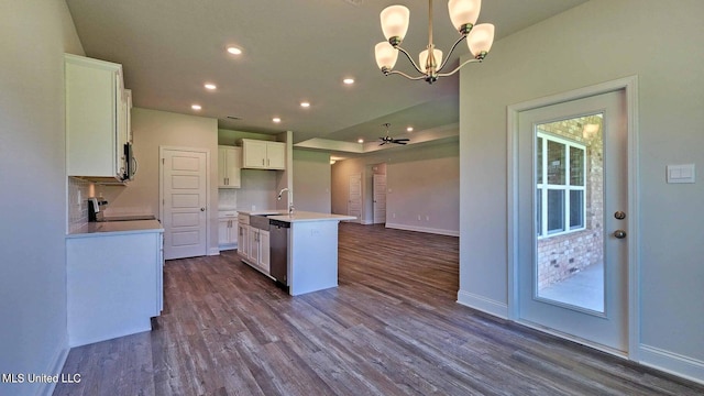 kitchen with a sink, appliances with stainless steel finishes, dark wood finished floors, and white cabinets