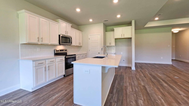 kitchen featuring a sink, visible vents, white cabinets, appliances with stainless steel finishes, and dark wood finished floors