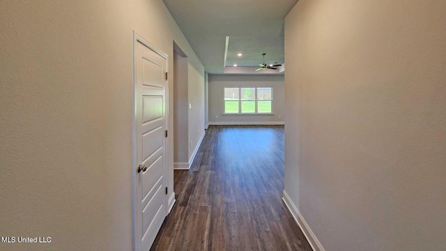 hallway with dark wood-style floors and baseboards