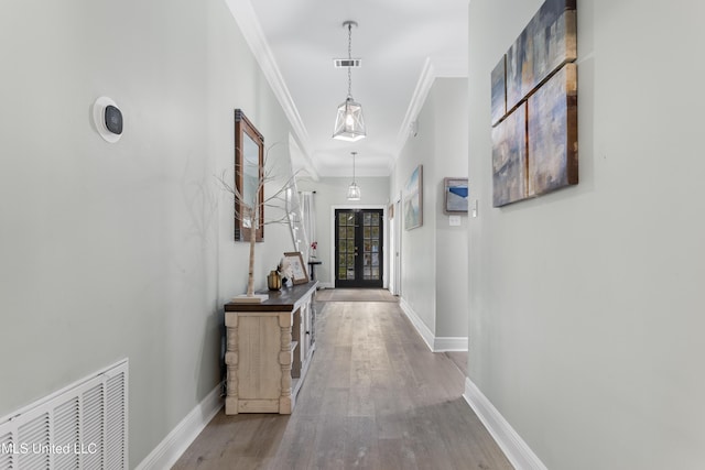 hall featuring crown molding, french doors, and wood-type flooring