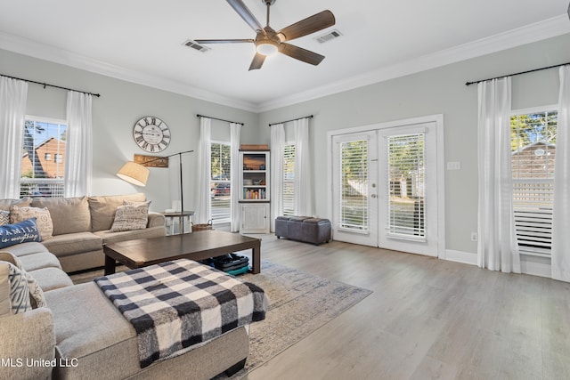 living room with crown molding, ceiling fan, french doors, and light hardwood / wood-style floors