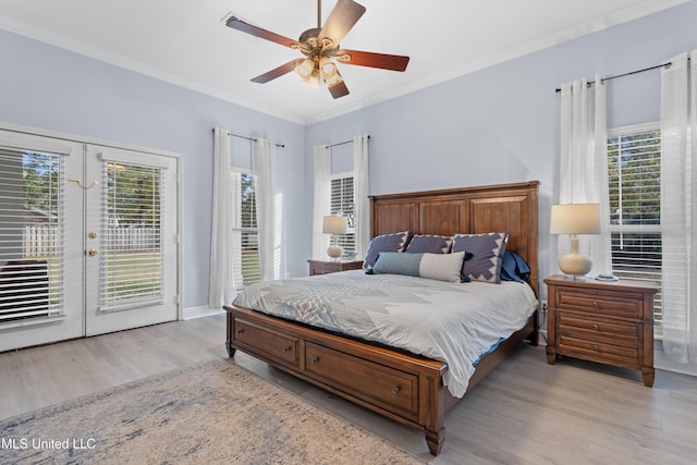 bedroom with french doors, access to outside, ceiling fan, multiple windows, and light hardwood / wood-style floors