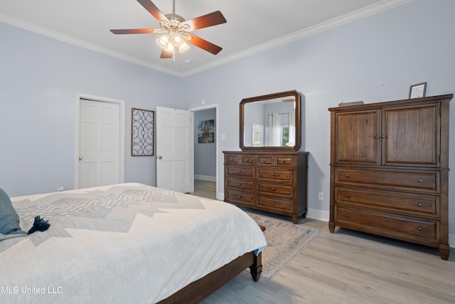 bedroom featuring ceiling fan, light hardwood / wood-style floors, and ornamental molding